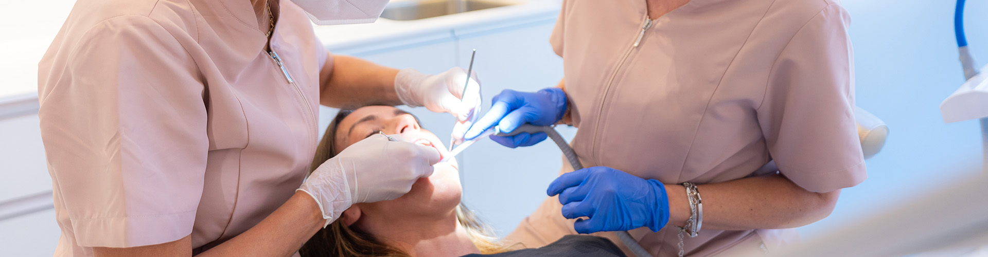 dental staff performing cleaning on patient