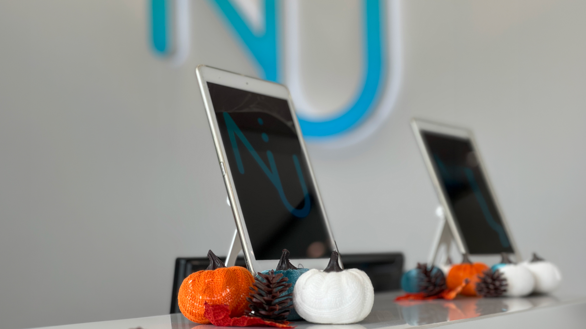 Dental office reception desk with check-in tablets and fall decorations