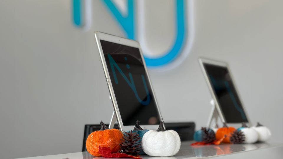 Dental office reception desk with check-in tablets and fall decorations