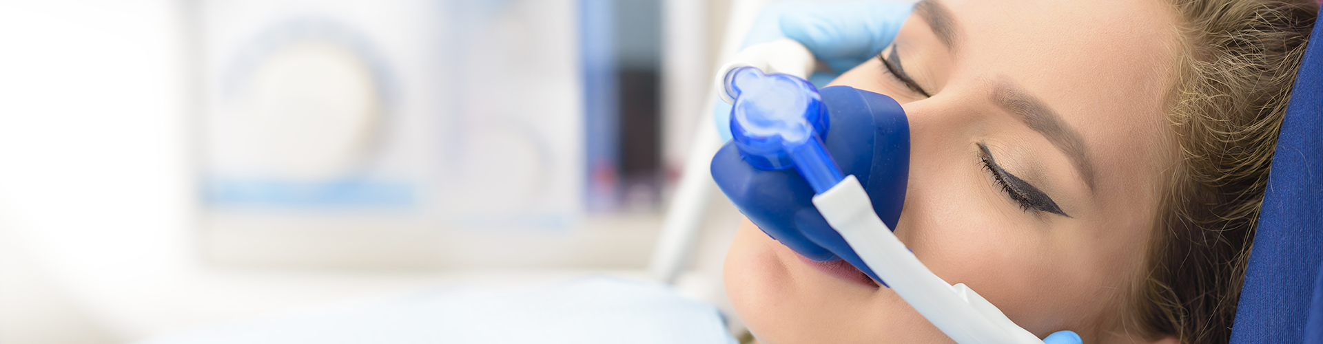 sedated woman wearing a nitrous oxide mask